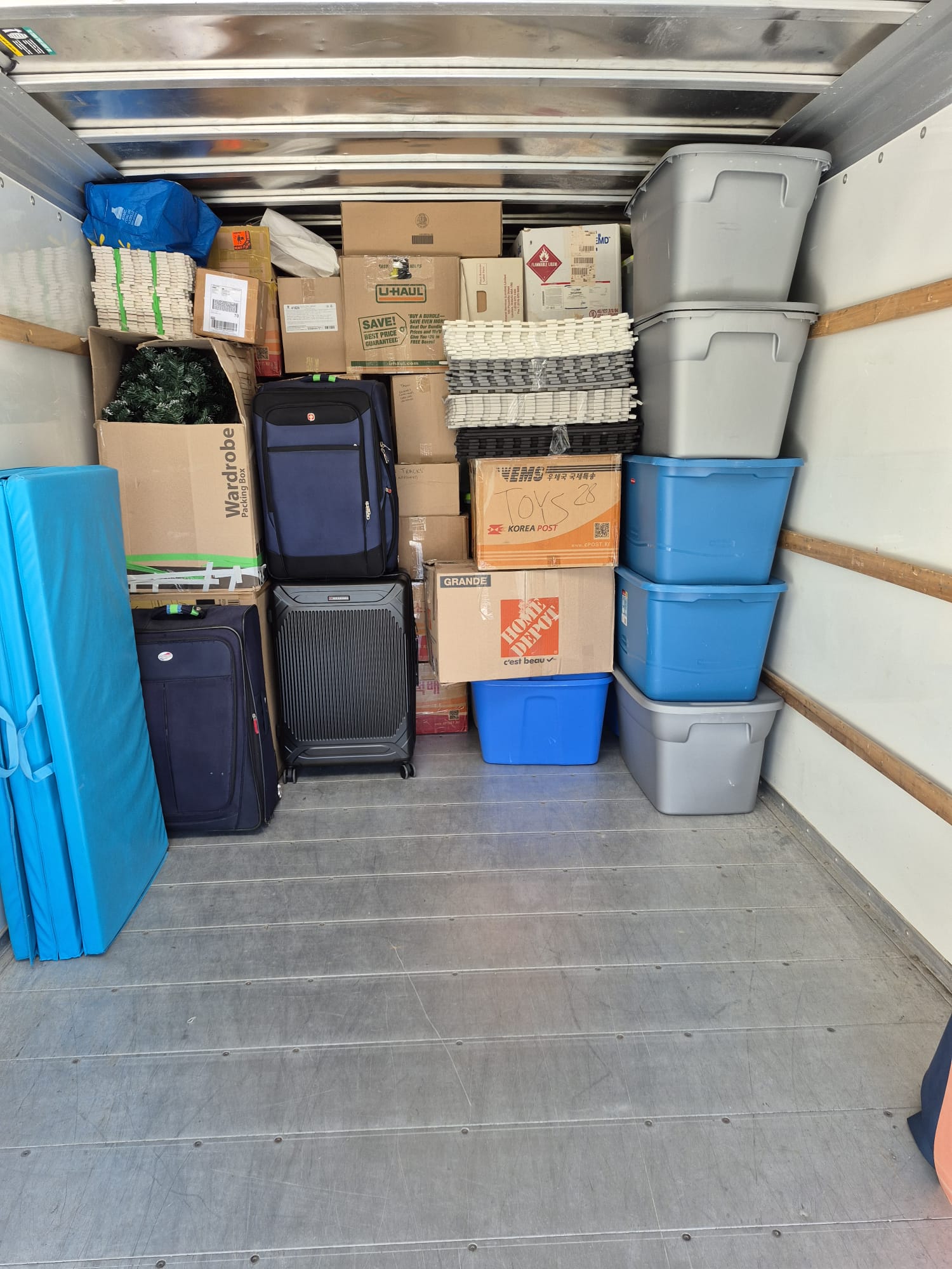 KG Elite Moving crew with a fully loaded truck after a successful London Ontario move
